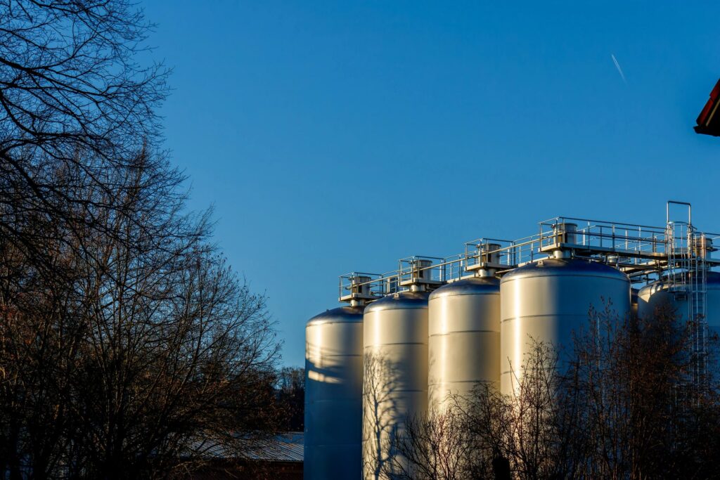 Industrial storage tanks against clear blue sky